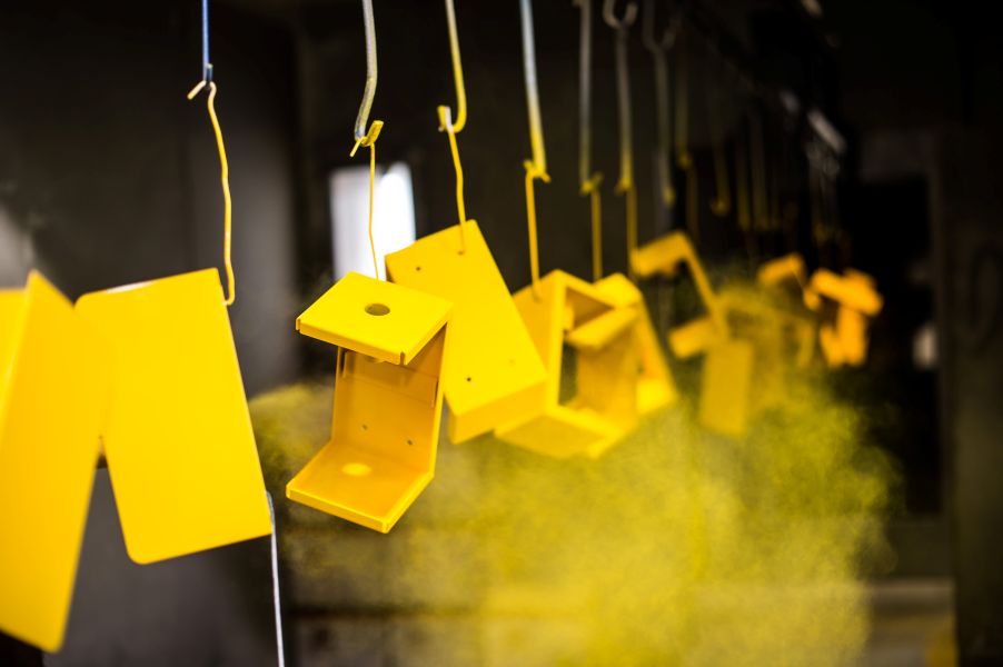 Parts being powder coated yellow